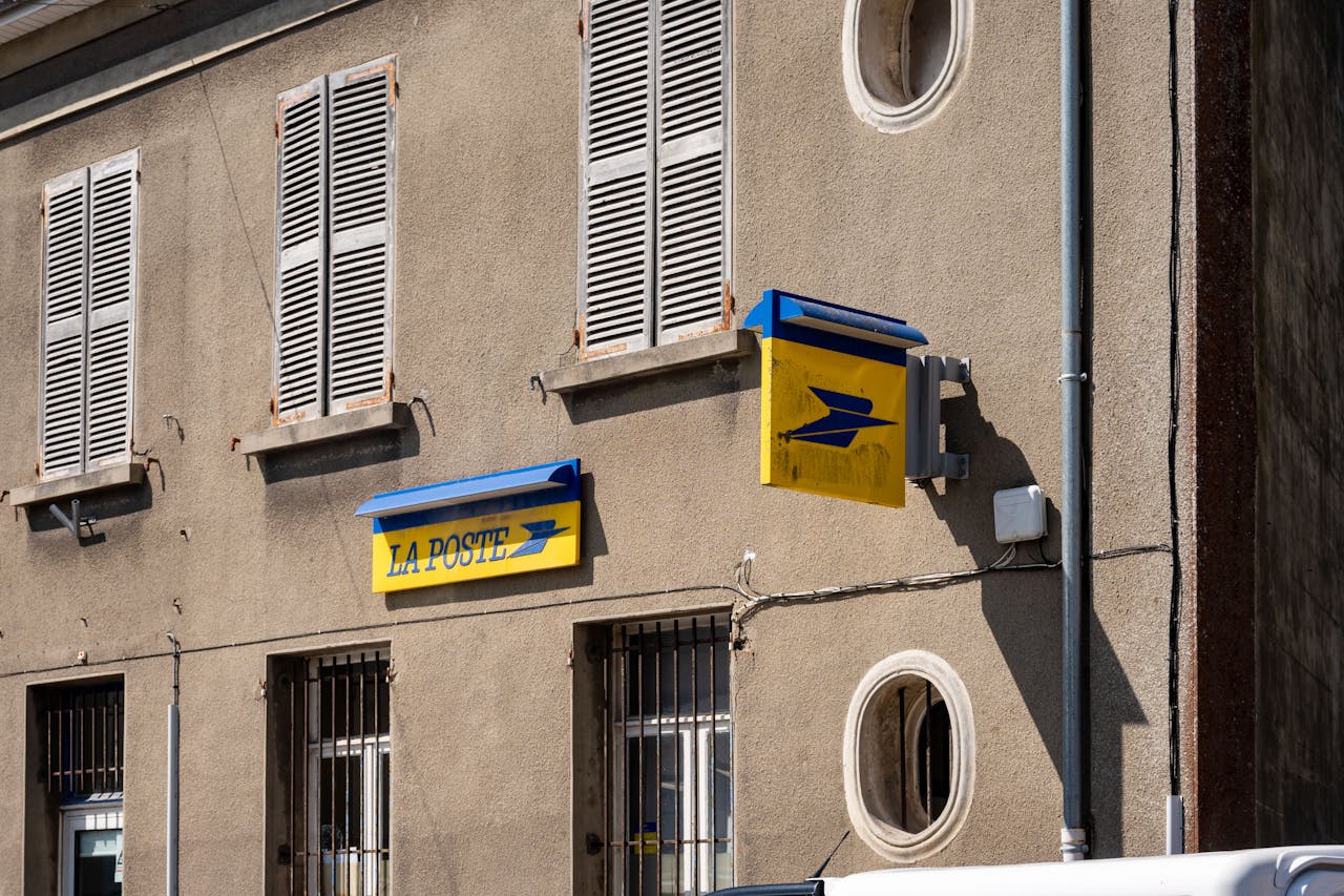 Street view of a La Poste building in France with its iconic signage.